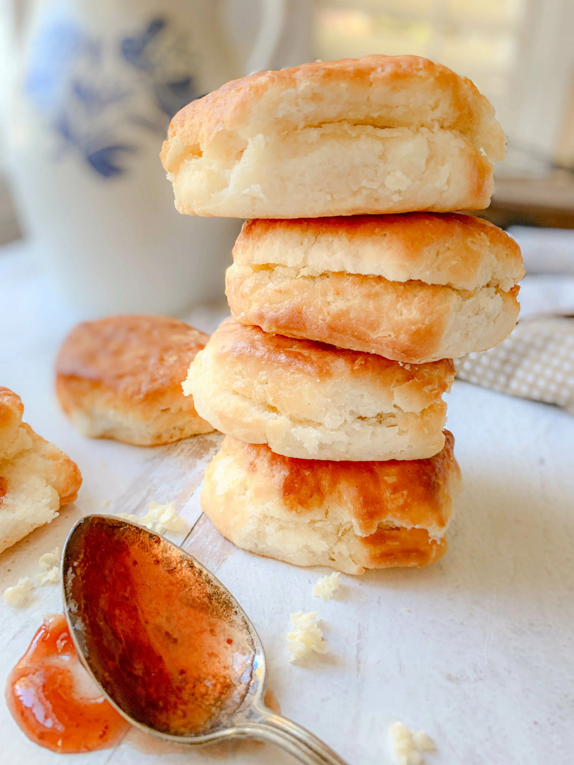 This photo shows 4 buttermilk biscuits stacked on top of each other. 