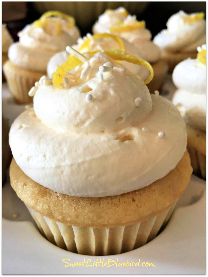 Photo of a Lemon Cupcakes baked and frosted on a white cupcake tray.