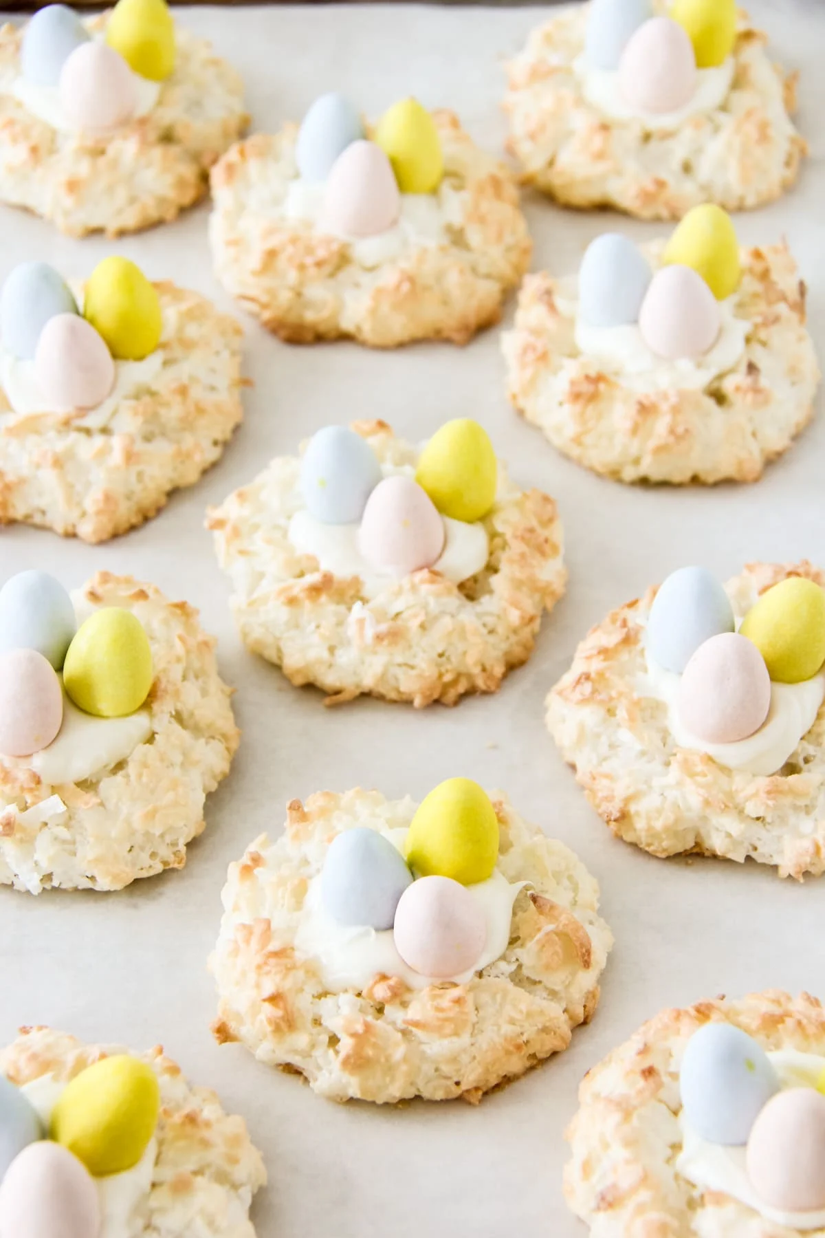This photo shows 11 Easter Coconut Macaroons on a white countertop, ready to eat. 