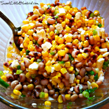 This photo shows Black-Eyed Peas and Corn Salsa in a clear glass mixing bowl.