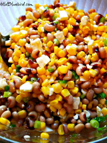 This photo shows Black-Eyed Peas and Corn Salsa in a clear glass mixing bowl.