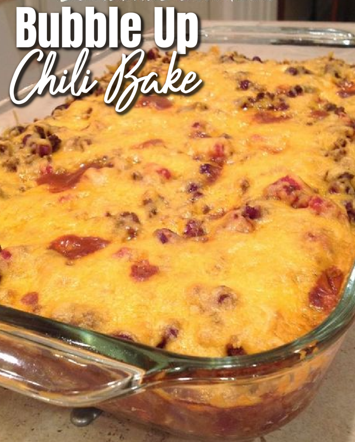 This image shows Bubble Up Chili Bake after baking in a clear glass baking dish.