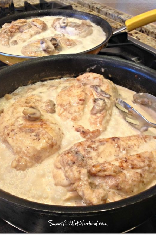 Photo of two skillets on stove cooking Chicken Breasts in Lemon Cream Sauce with Mushrooms.