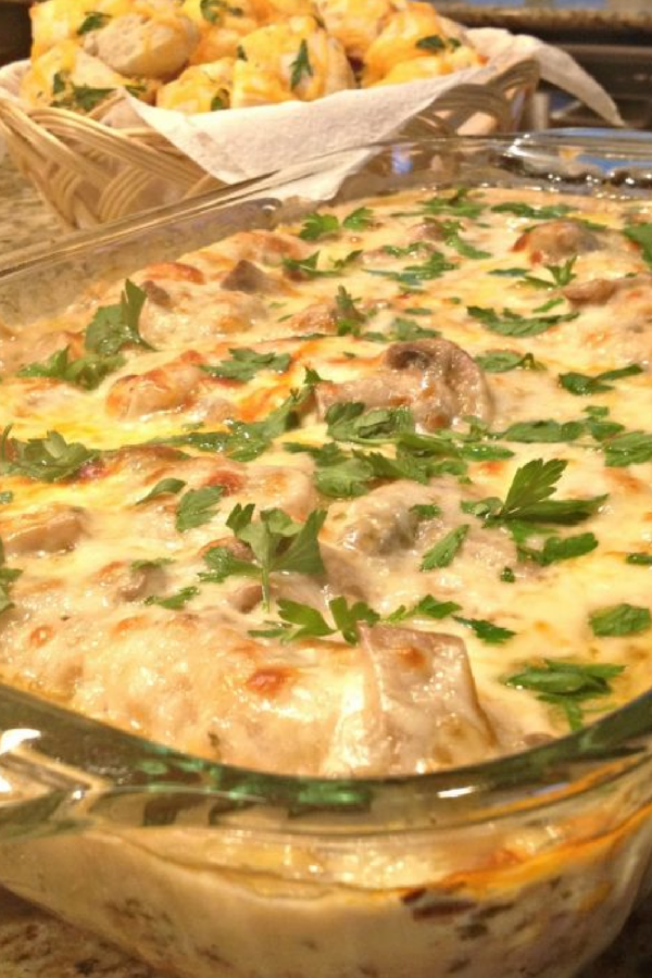 This photo show Chicken Gloria Casserole after baking in a clear baking dish. 