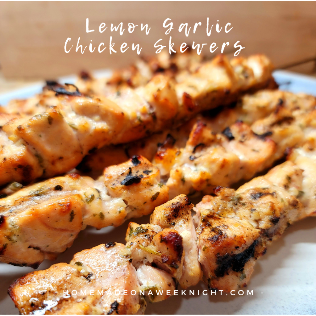This photo shows a plate filled with Lemon Garlic Chicken Skewers.