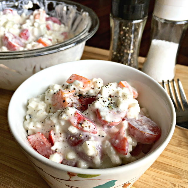This photo show Grandma's Cottage Cheese Salad in a clear glass mixing bowl with a small serving bowl next to it, filled with the salad, ready to eat. 