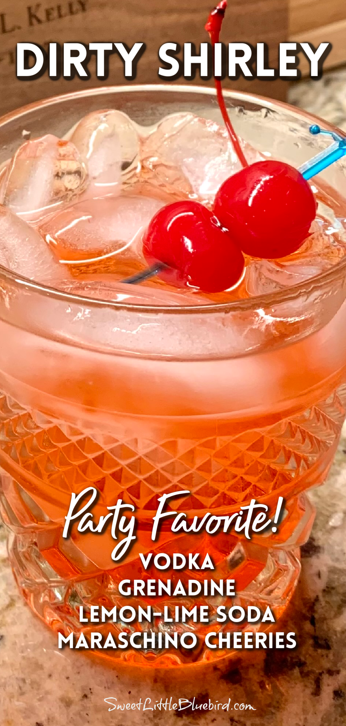 This image shows a Dirty Shirley in a glass, garnished with two maraschino cherries. There is a text graphic with the ingredients listed on the photo. 
