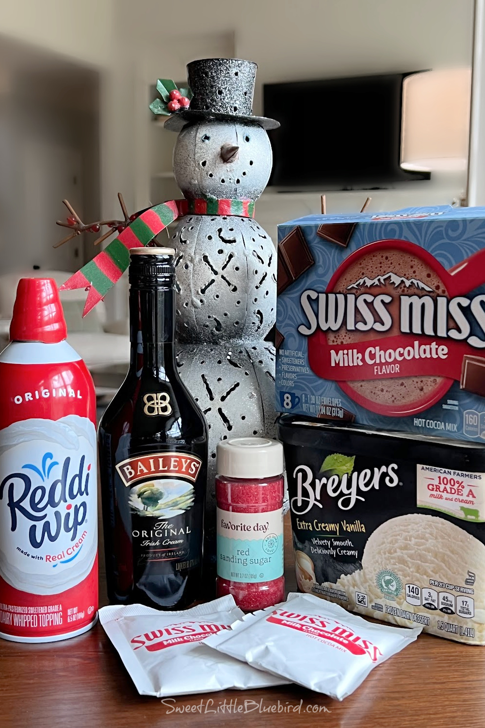 This photo shows all the ingredients needed to make a Dirty Snowman Cocktail on a kitchen table. 