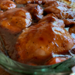 This image shows Baked Teriyaki Chicken in a clear baking dish.
