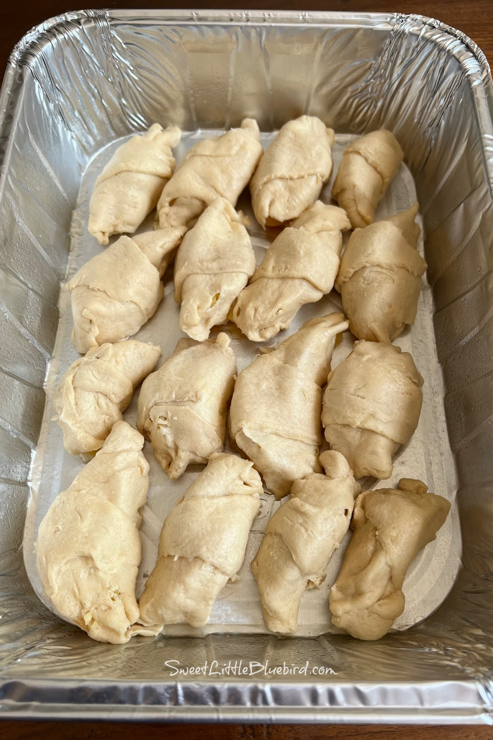 This photo shows the dumplings after rolling, placed in the baking pan.