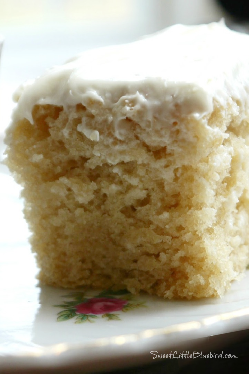 This is a close up photo of a slice of Vanilla Crazy Cake served on a plate. 