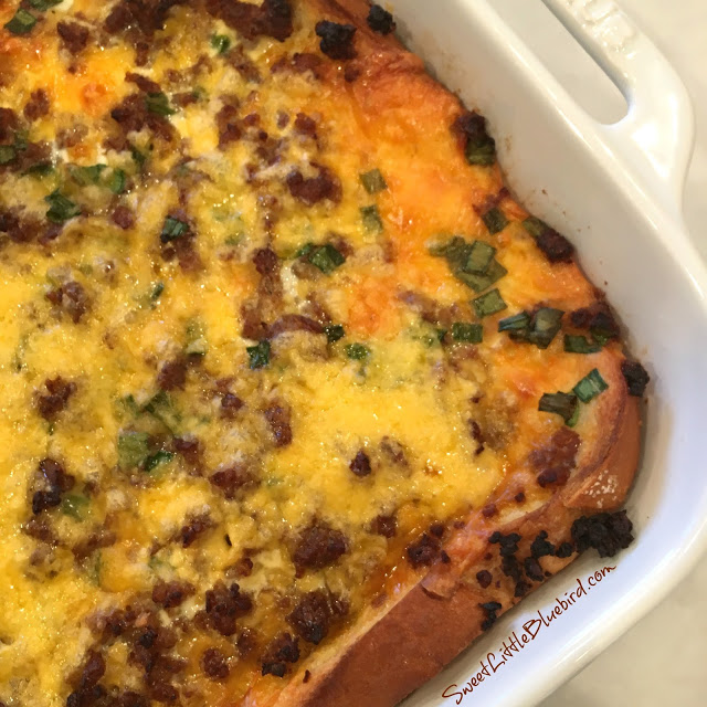 Photo of the sausage, egg and cheese casserole baked in white baking dish.