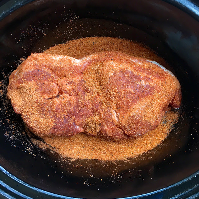 This is a photo of the pork shoulder in the slow cooker with the rub ready to be slow cooked. 