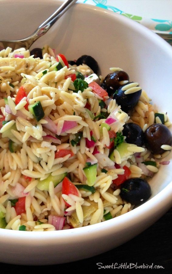 This is a photo of Greek Orzo Salad served in a white bowl. 