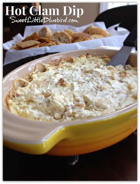 This is a photo of clam dip baked in an oval yellow and cream colored baking dish. 