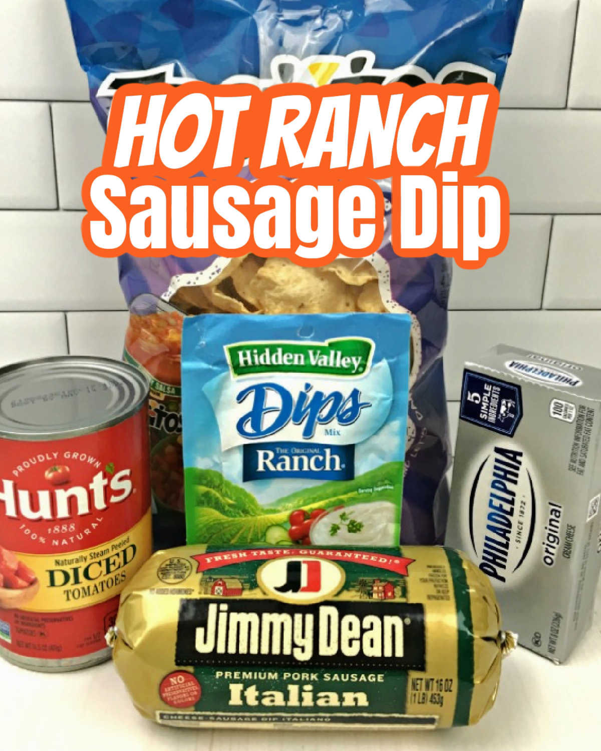 This photo shows the ingredients to make Hot Ranch Sausage Dip - packet of ranch dip mix, block of cream cheese, can of diced tomatoes and Italian sausage. Behind the ingredients is a bag of tortilla chips.