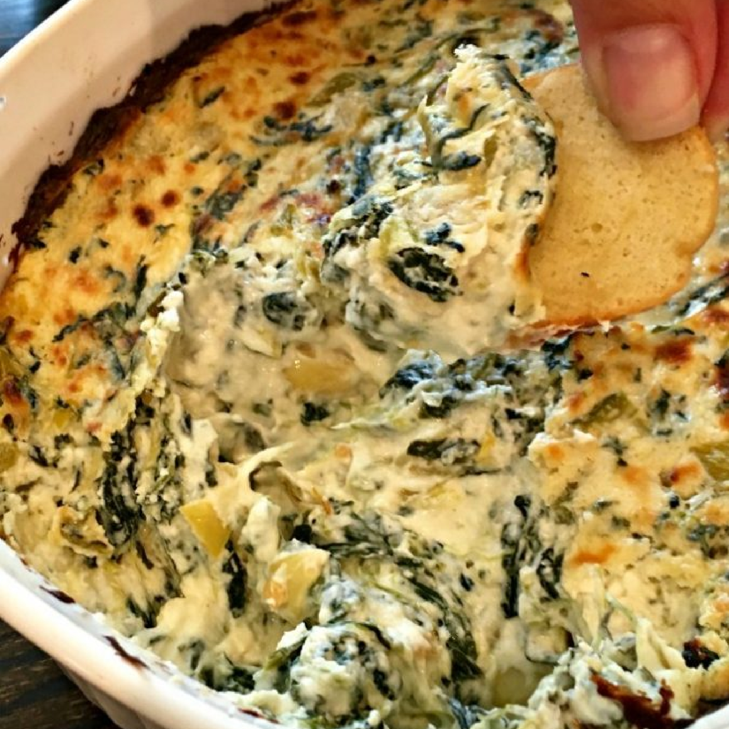 This photo shows a spinach artichoke dip after baking.