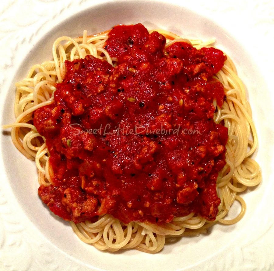 Photo of Jo Mama's Spaghetti Sauce served on top of spaghetti in a white bowl.