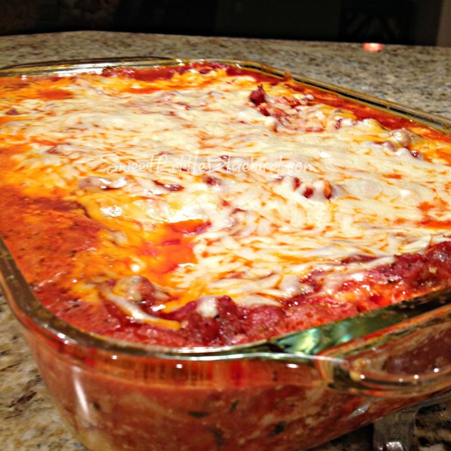 Photo of baked lasagna in a clear glass baking dish made with Jo Mama's Spaghetti Sauce