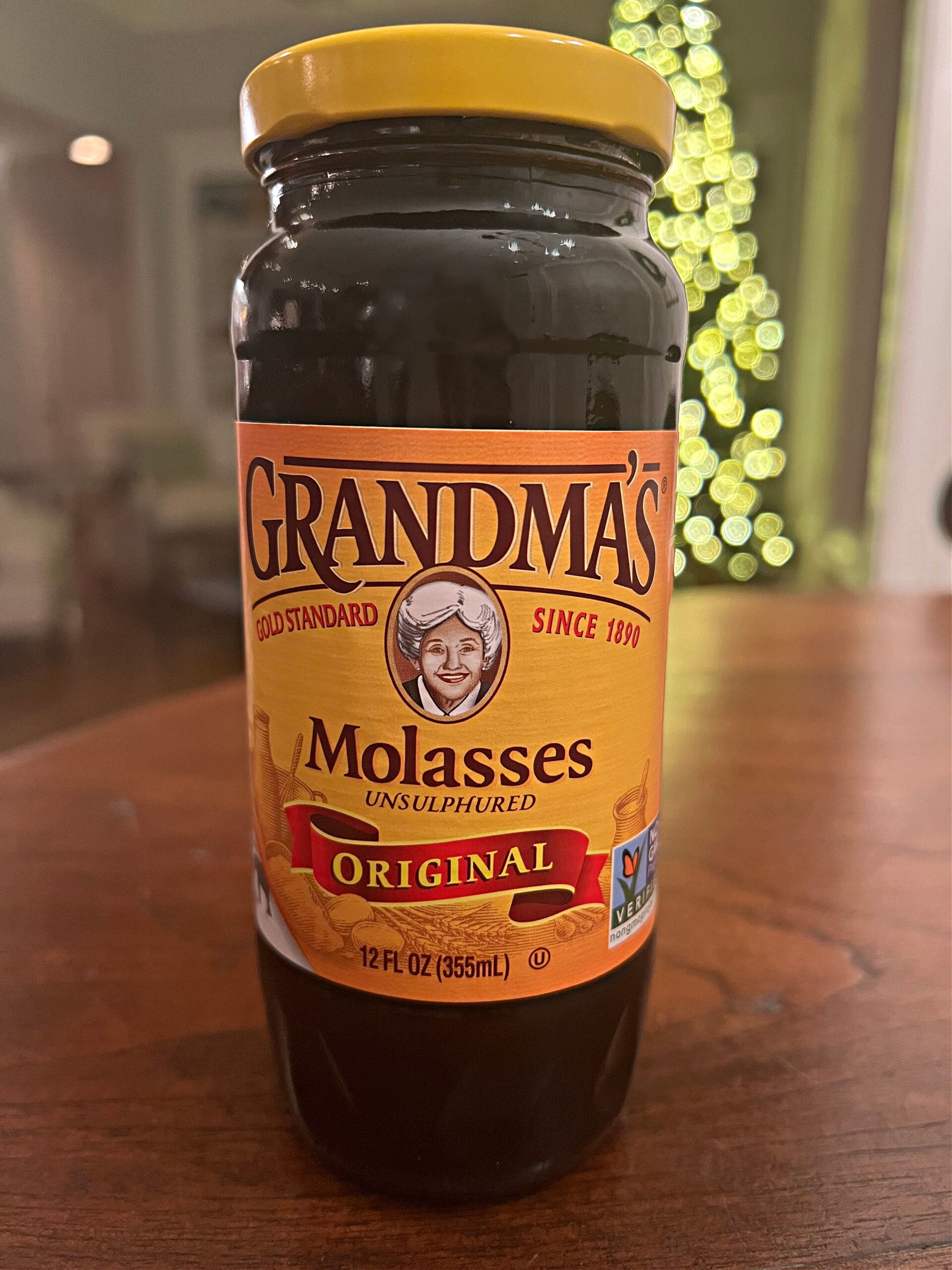 This is a bottle of Grandma's Molasses on a kitchen table. 