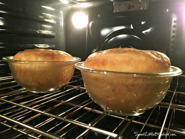 This photo shows 2 loaves of the bread baking in round oven-proof pyrex bowls .