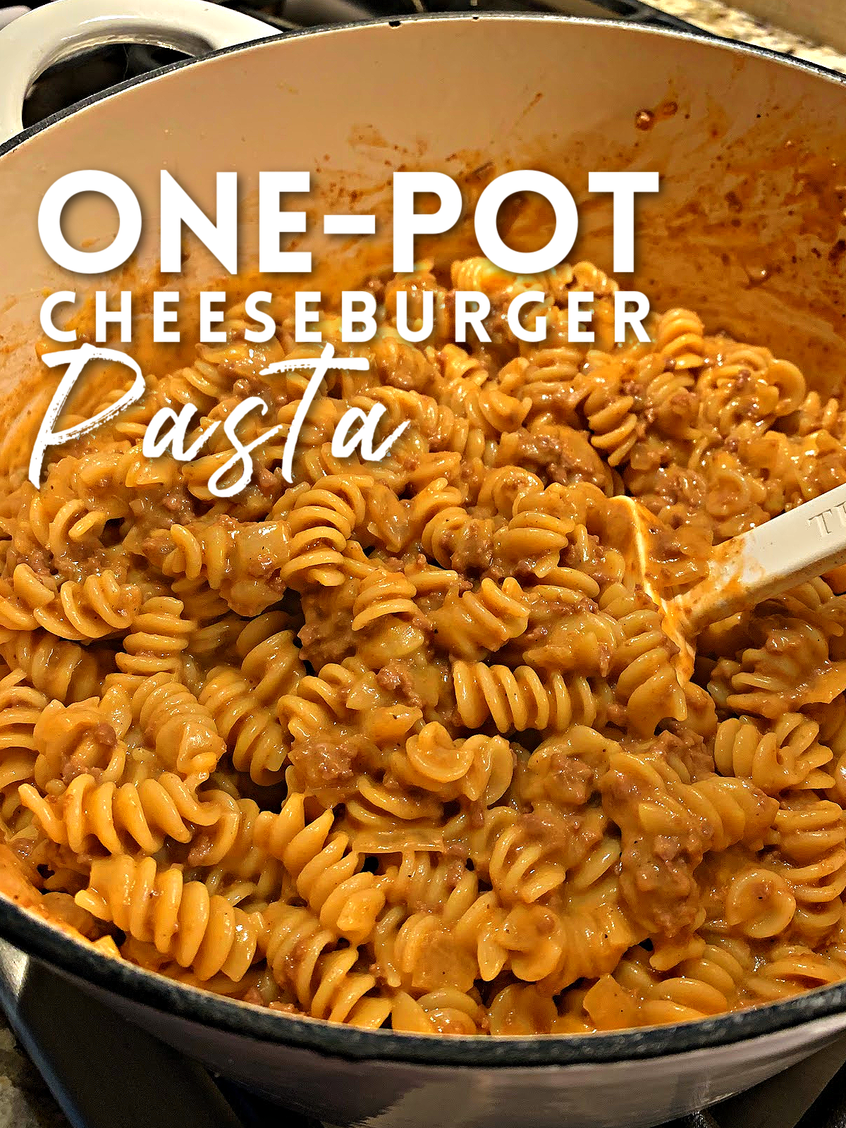 This image shows cheeseburger pasta in a pot, ready to serve. 