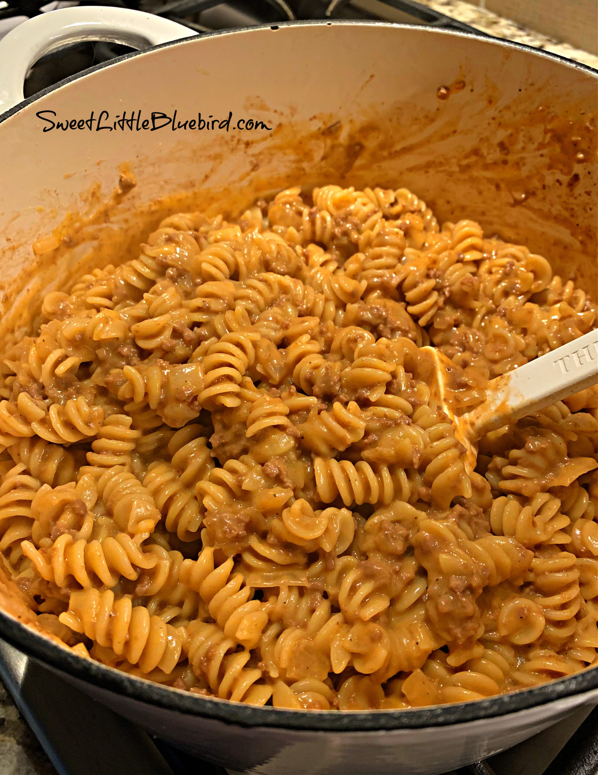 This photo show cheeseburger pasta cooked in a pot. 