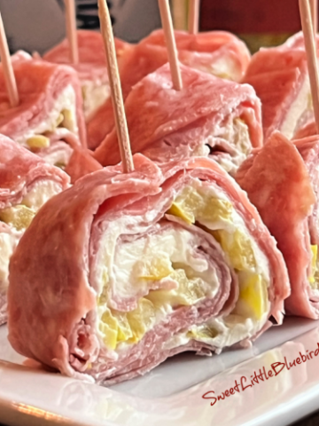 This is a photo of Salami Cream Cheese Roll-Ups served on a white plate.
