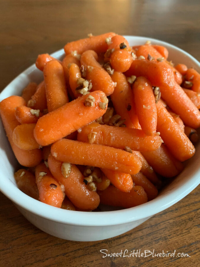Skillet Maple-Glazed Carrots with Pecans served in a white oval serving dish. 