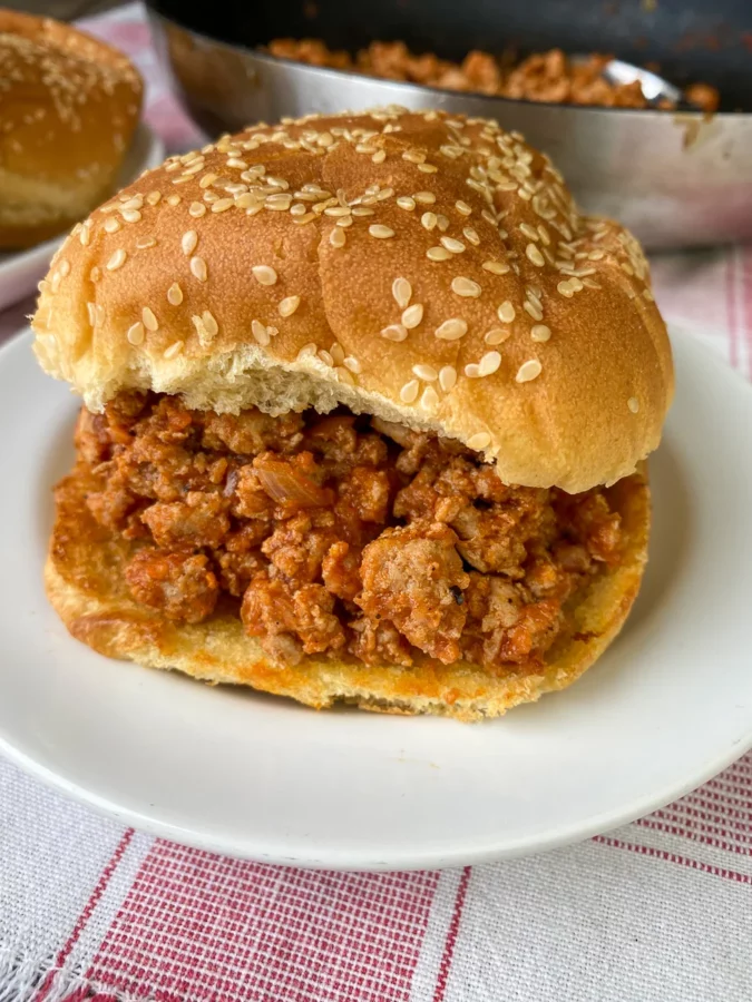 Photo of a Sloppy Jane Sandwich served on a white plate.