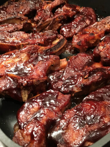 This photo shows Slow Cooker Barbecue Country-Style Ribs in a pan, ready to serve.