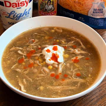 Slow Cooker Salsa Verde Chicken Soup served in a white bowl.