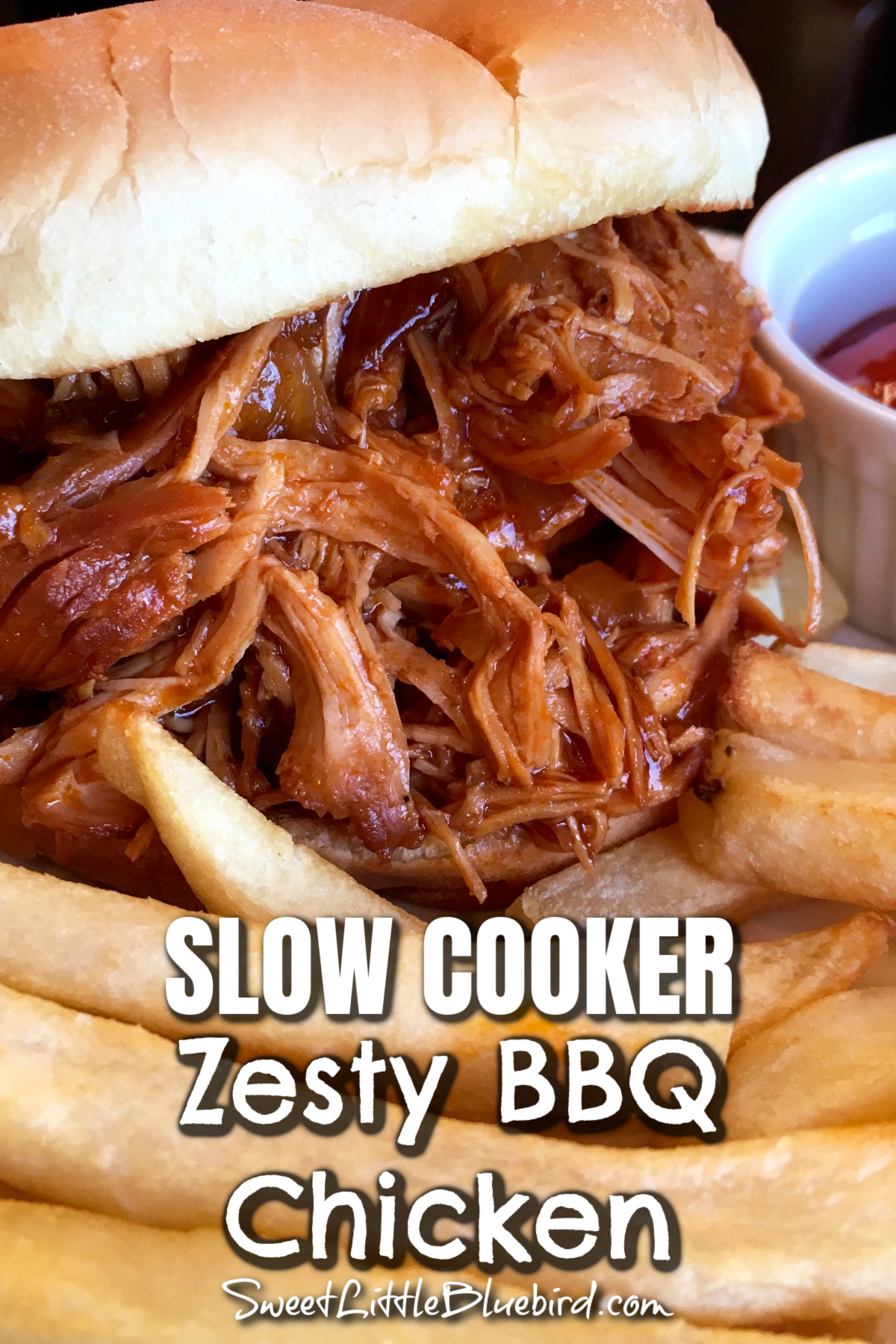 This image shows Zest BBQ Chicken on a roll with a side of french fries. 