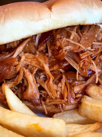 Slow Cooker Zesty BBQ Chicken served on a roll.