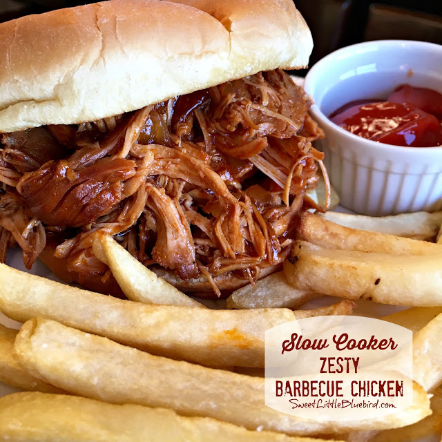 Slow Cooker Zesty Barbecue Chicken served in a roll with fries. 