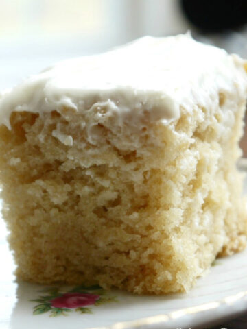 This is a photo of Vanilla Crazy Cake with vanilla frosting served on a plate.
