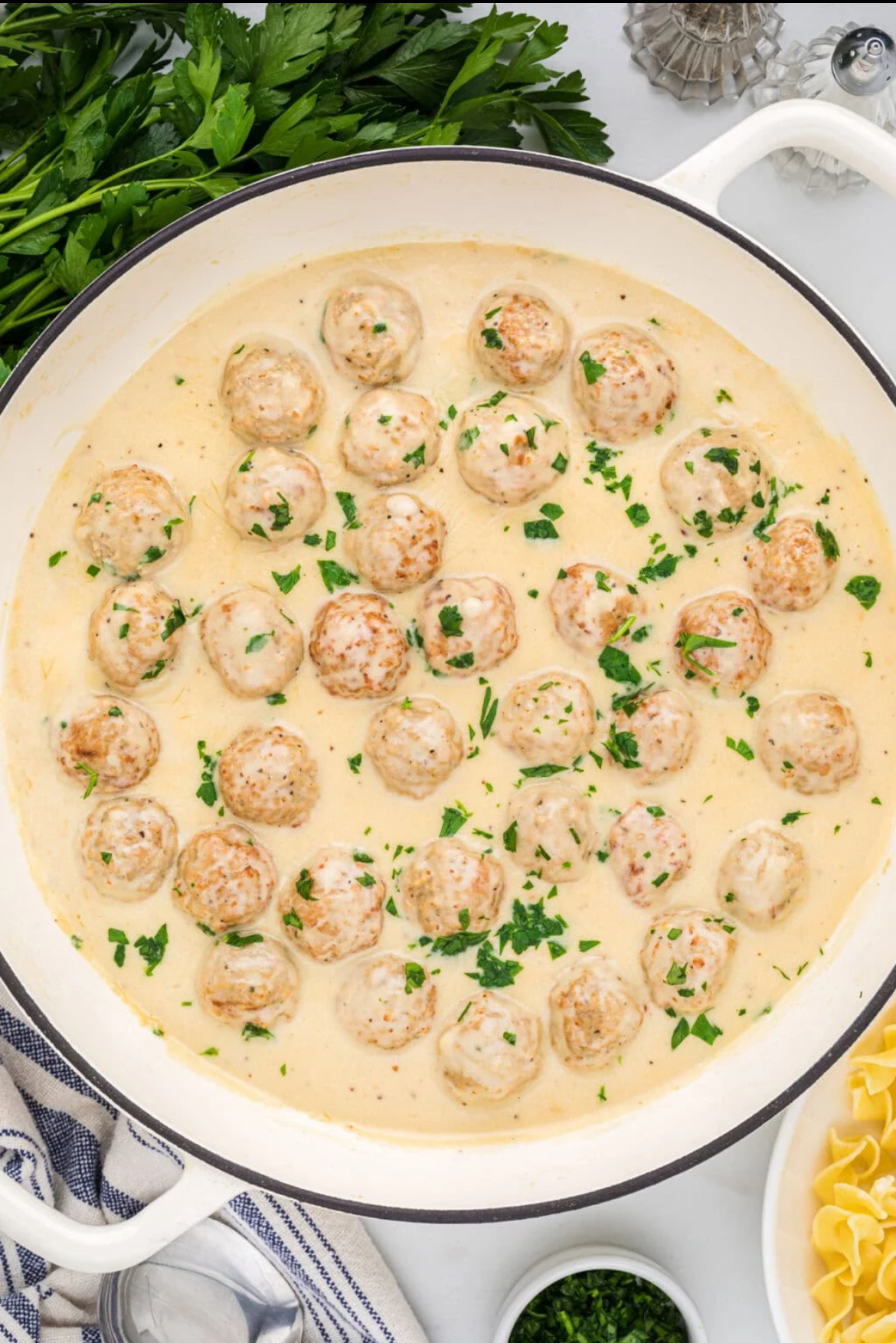 Easy Swedish Meatballs cooked in white Dutch oven, ready to serve.
