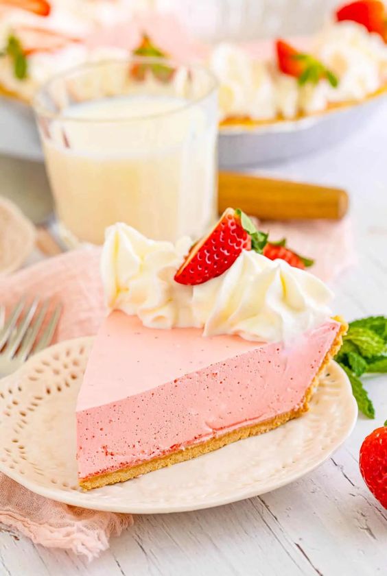 Photo o fStrawberry Jello Pie on a white plate with a glass of milk behind it, by Bakerish