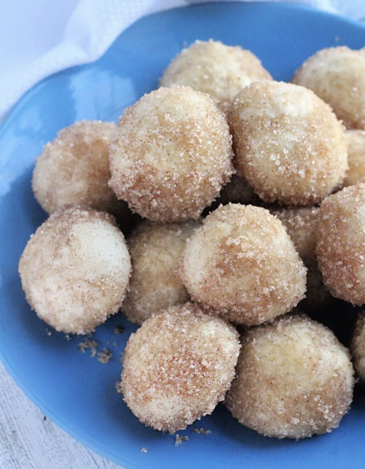 This image show donut holes on a blue plate.