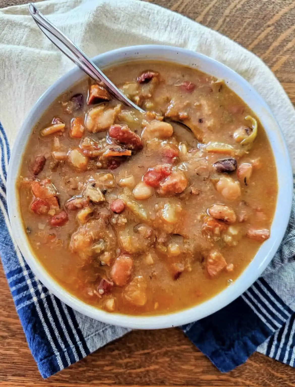 This image shows Kielbasa and 15-Bean Soup in a bowl with a spoon.
