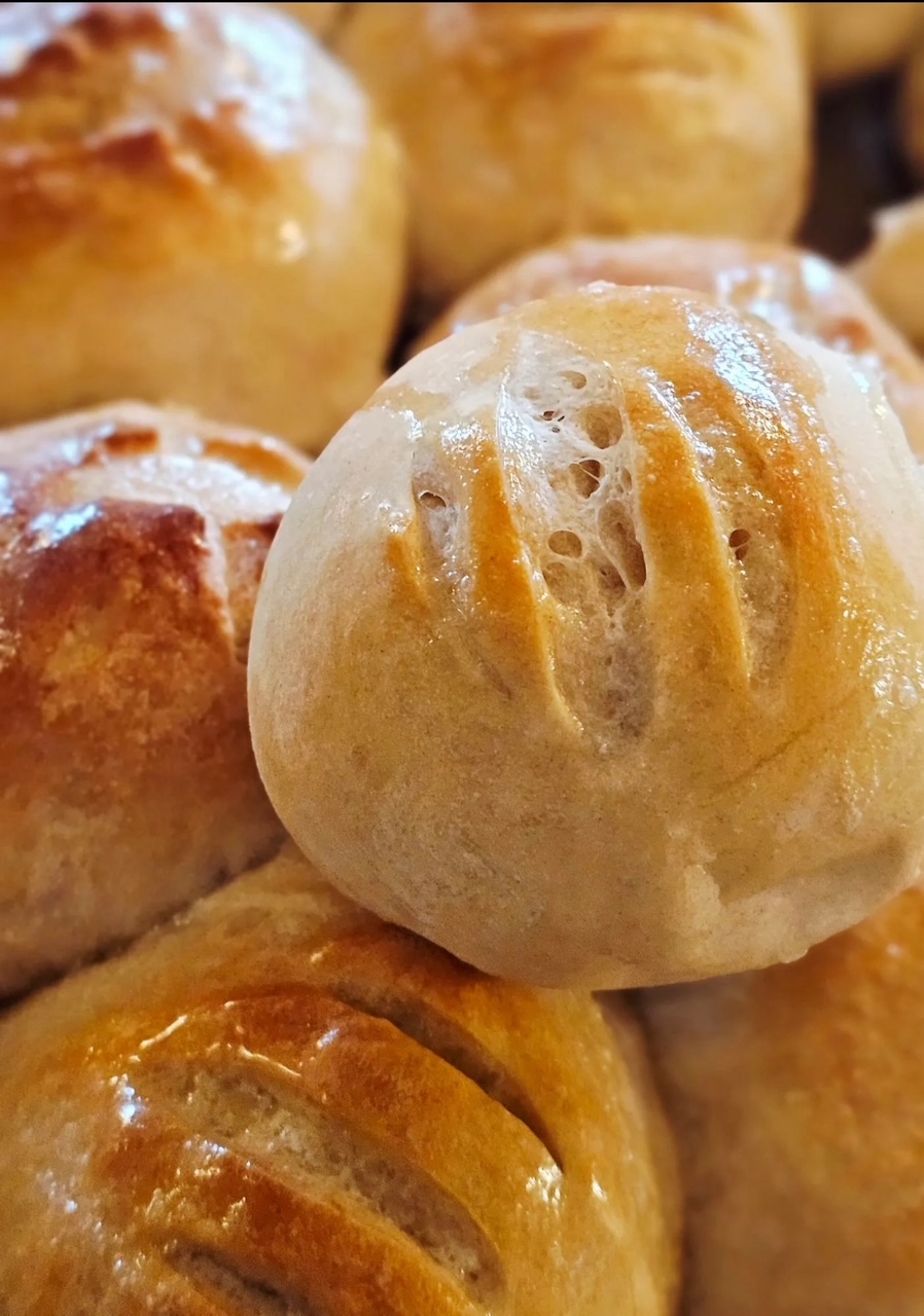 Close up photo of seven sourdough dinner rolls. 