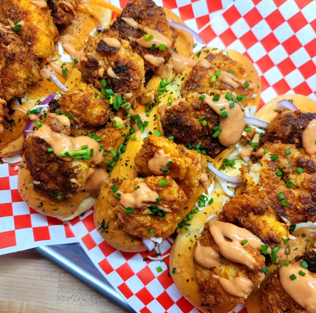 Crispy Shrimp Rolls Five Crispy Shrimp Rolls served on top of red and white checkered parchment paper.