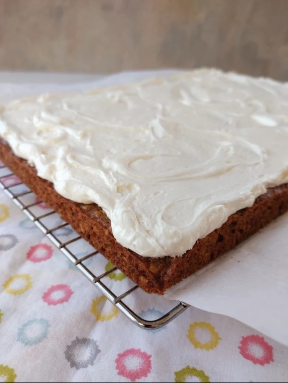 Oatmeal Cream Pie Bars Oatmeal Cream Pie Bar on a wire rack, frosted, ready to cut into bars.