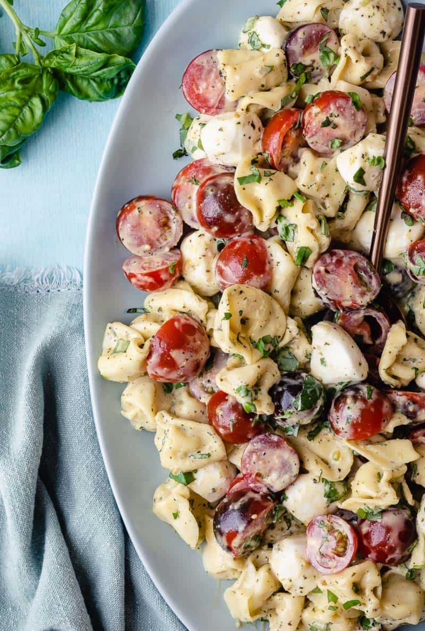 Tortellini Caprese Salad served in white serving bowl. 