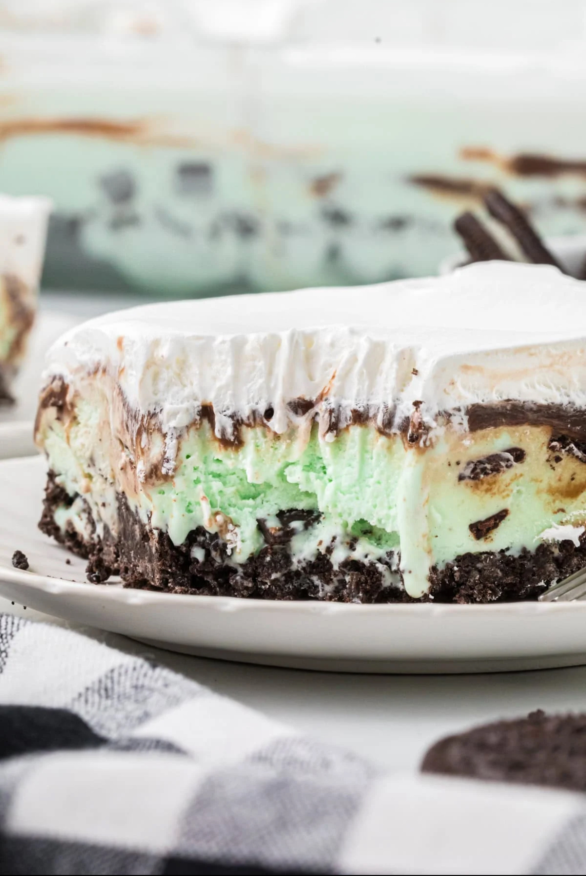 Grasshopper Ice Cream Pie A piece of Grasshopper Ice Cream Pie served on a white plate.