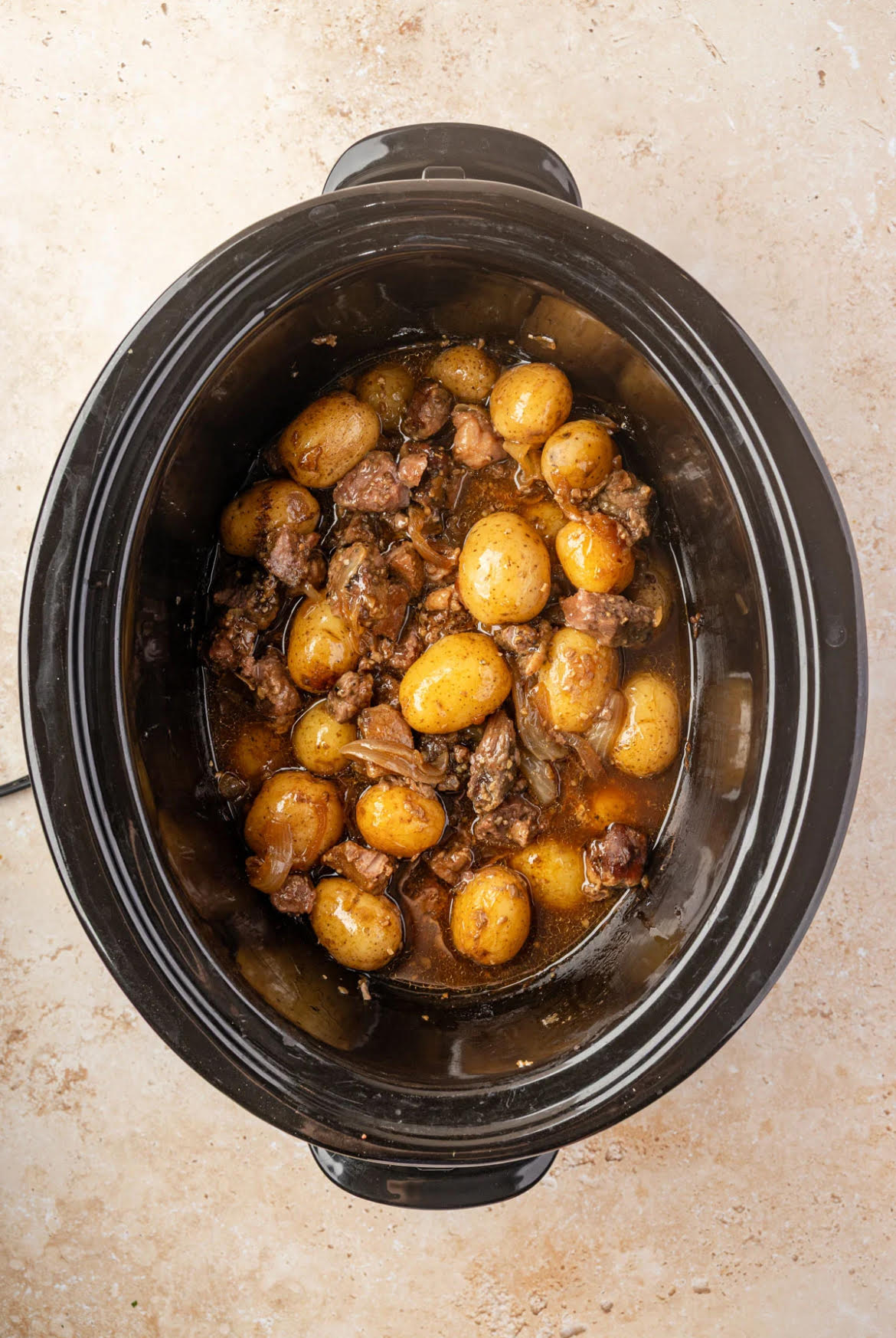 Slow Cooker Steak and Potatoes Steak and Potatoes in a black Crock Pot Bowl.
