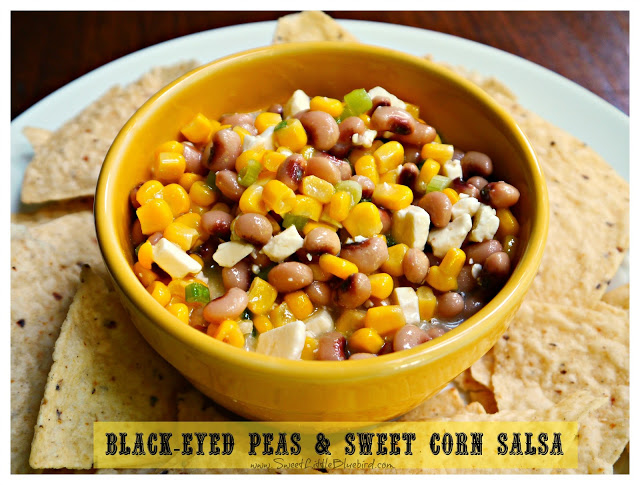 This photo shows Black-Eyed Peas Sweet Corn Salsa served in a yellow bowl with tortilla chips. 