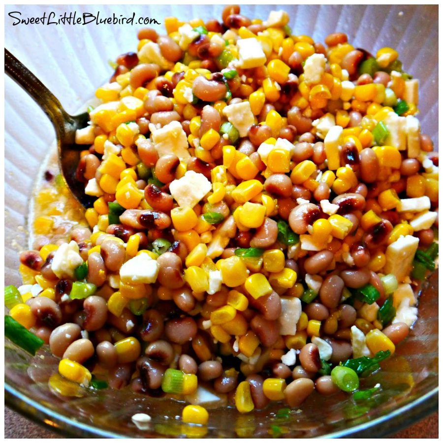 This photo shows Black-Eyed Peas and Corn Salsa in a clear glass mixing bowl. 