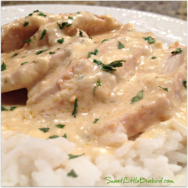 This is a photo of Creamy Hidden Ranch Chicken served in a white bowl over white rice.