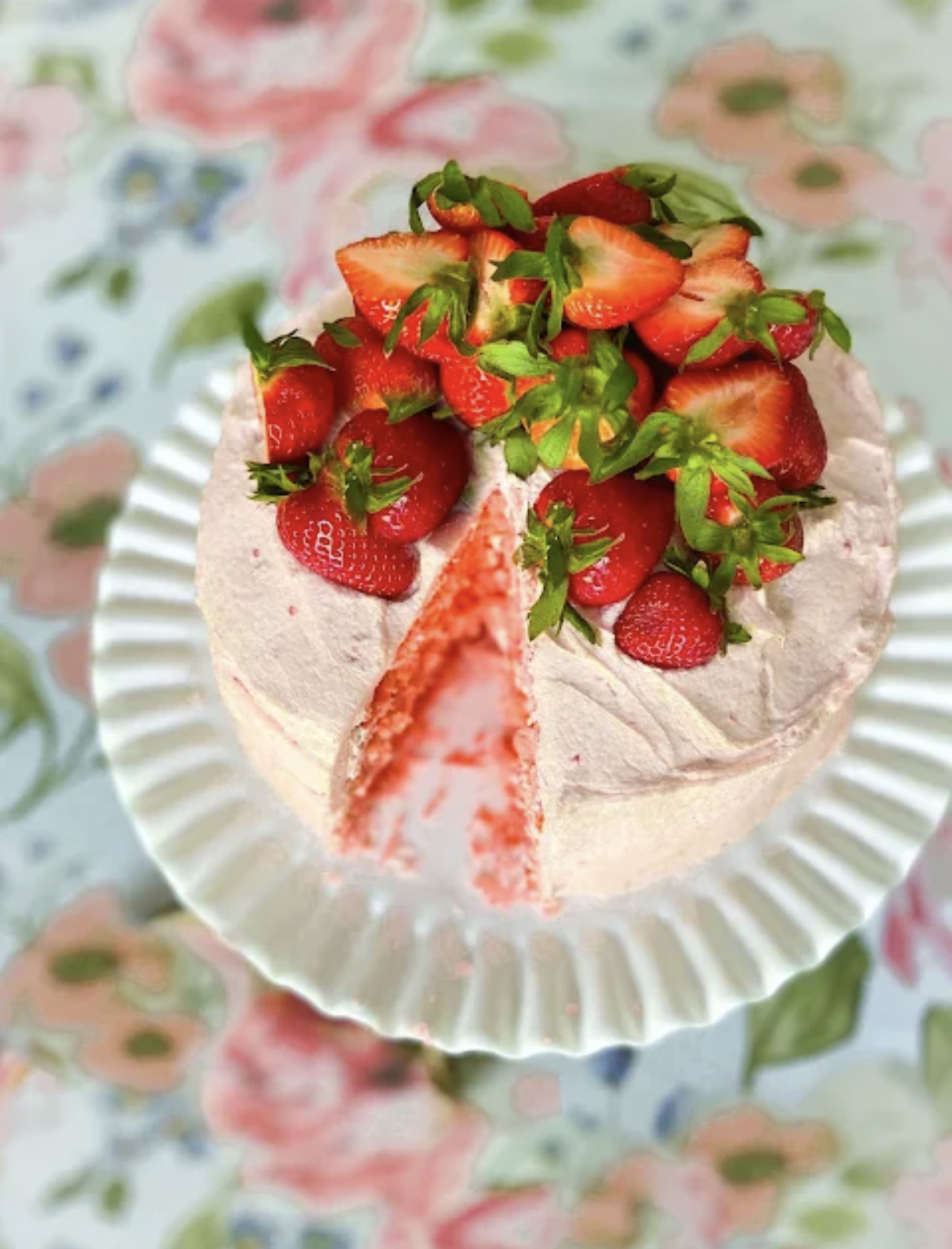 This image shows Fresh Strawberry Cake on a cake plate.